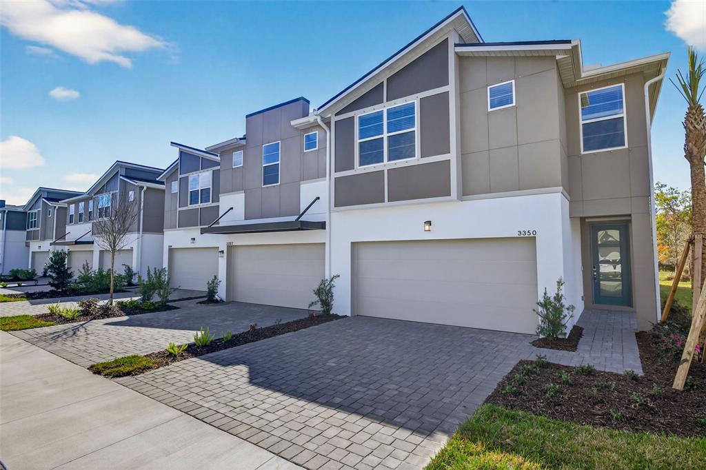 3350 Timber Xing Avenue Brandon, FL 33511 - Photo 1 of 35 a front view of a house with a yard and garage