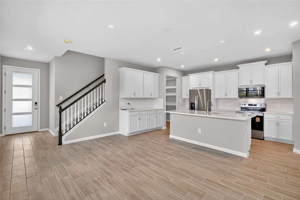 3350 Timber Xing Avenue Brandon, FL 33511 - Photo 11 of 35 a kitchen with white cabinets stainless steel appliances and sink