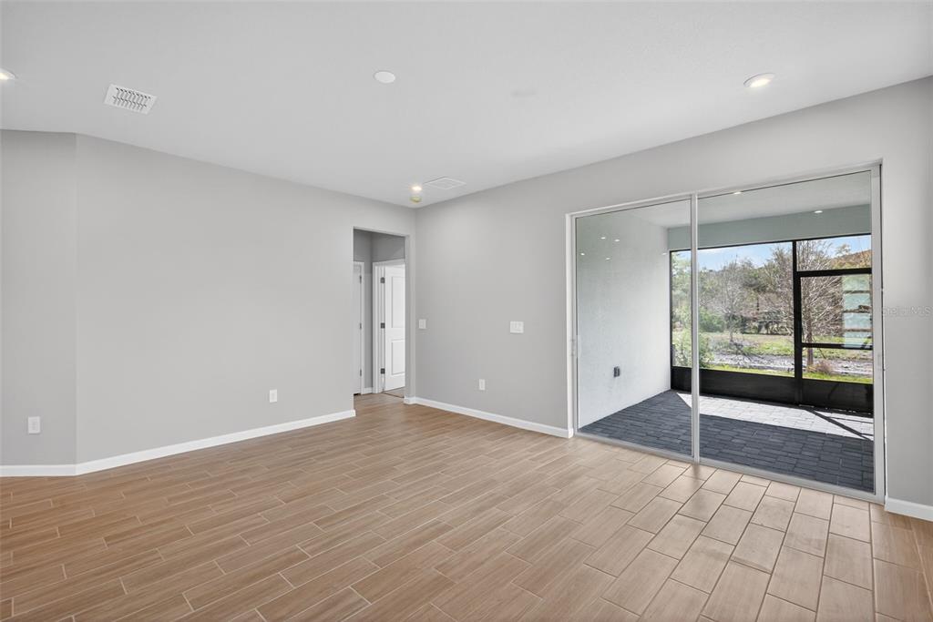 3350 Timber Xing Avenue Brandon, FL 33511 - Photo 12 of 35 wooden floor in an empty room with a window