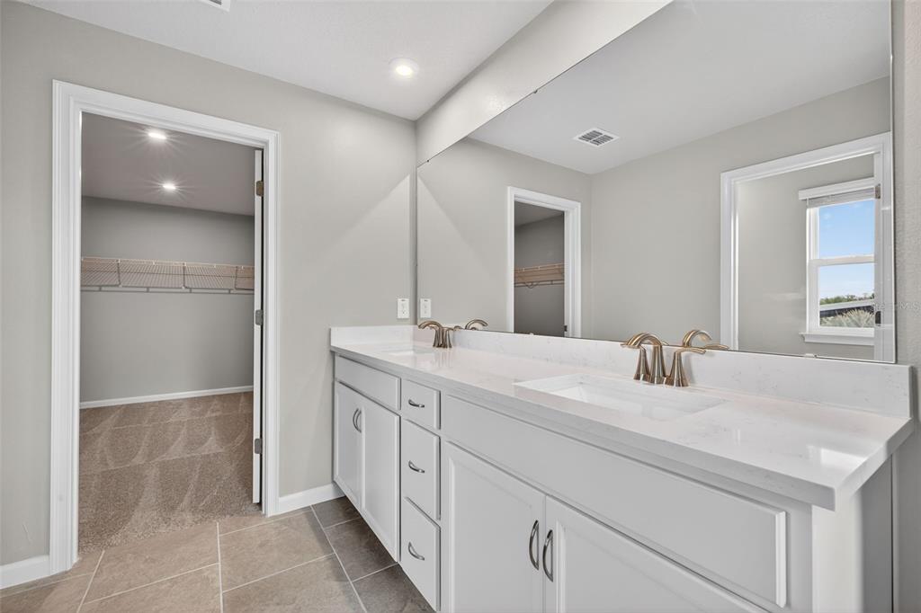 3350 Timber Xing Avenue Brandon, FL 33511 - Photo 22 of 35 a bathroom with a double vanity sink and a mirror