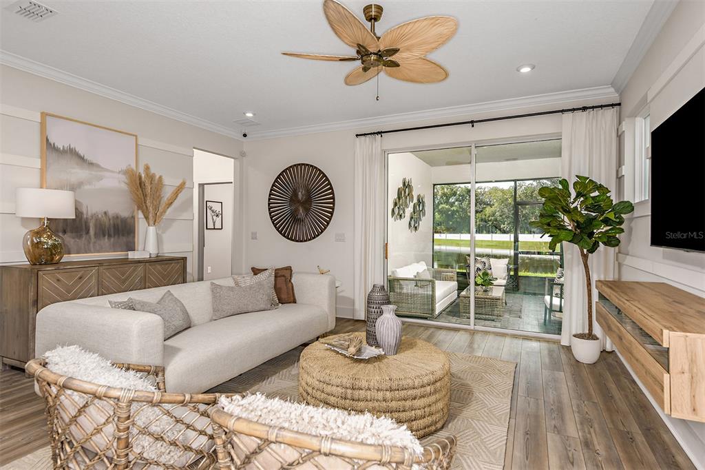 3350 Timber Xing Avenue Brandon, FL 33511 - Photo 6 of 21 a living room with furniture a chandelier and a large window
