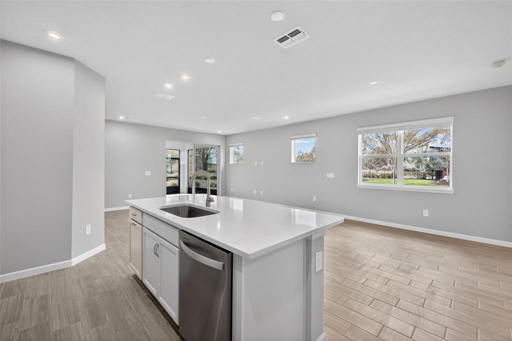 3350 Timber Xing Avenue Brandon, FL 33511 - Photo 6 of 35 a kitchen that has a sink a stove and wooden floor