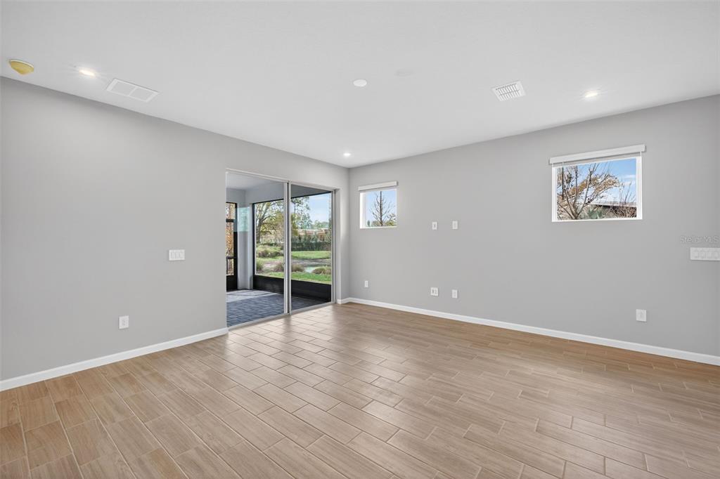 3350 Timber Xing Avenue Brandon, FL 33511 - Photo 10 of 35 a view of an empty room with wooden floor and a window