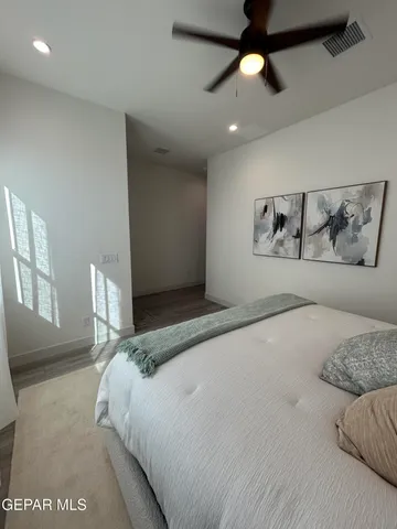 a bedroom with a large bed and a chandelier