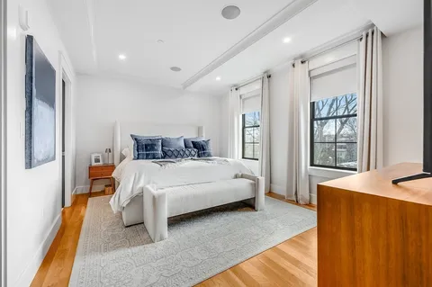 a bedroom with a large bed and a window