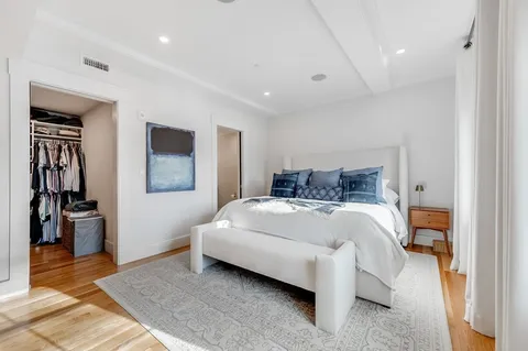 a spacious bedroom with a bed and a walk in closet