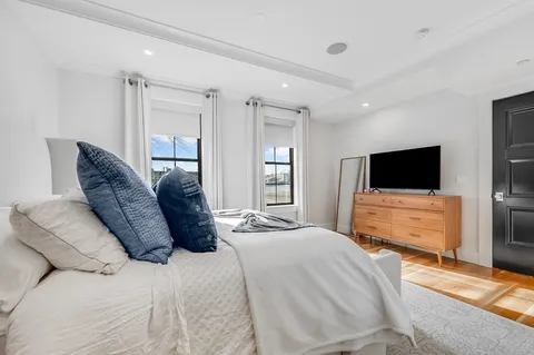 a bedroom with a bed and a flat screen tv