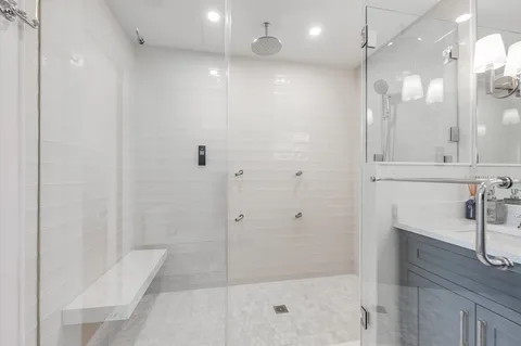a bathroom with a shower and a sink