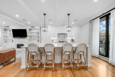 a large kitchen with a table and chairs in it
