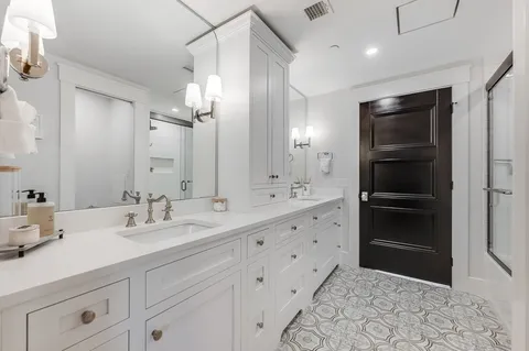 a bathroom with a double vanity sink and a mirror