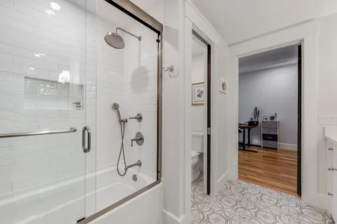 a bathroom with a shower and a mirror