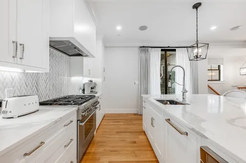 a kitchen with stainless steel appliances granite countertop a stove and a sink