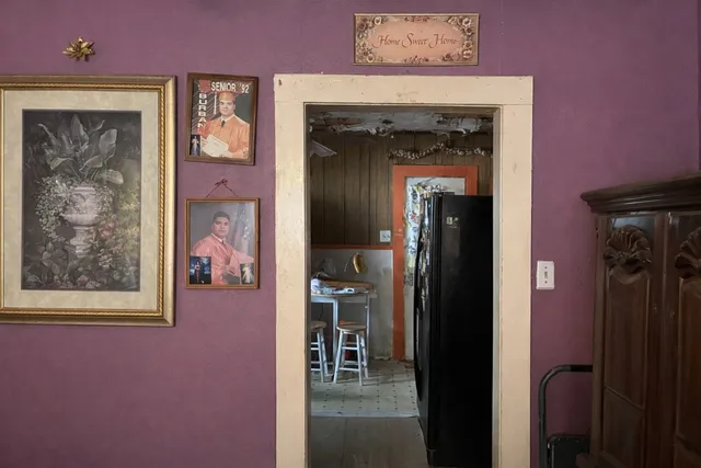 a view of a hallway with paintings on the wall