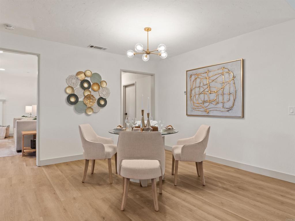 13737 Temple Street Poway, CA 92064 - Photo 9 of 38 a view of a dining room with furniture a chandelier and wooden floor