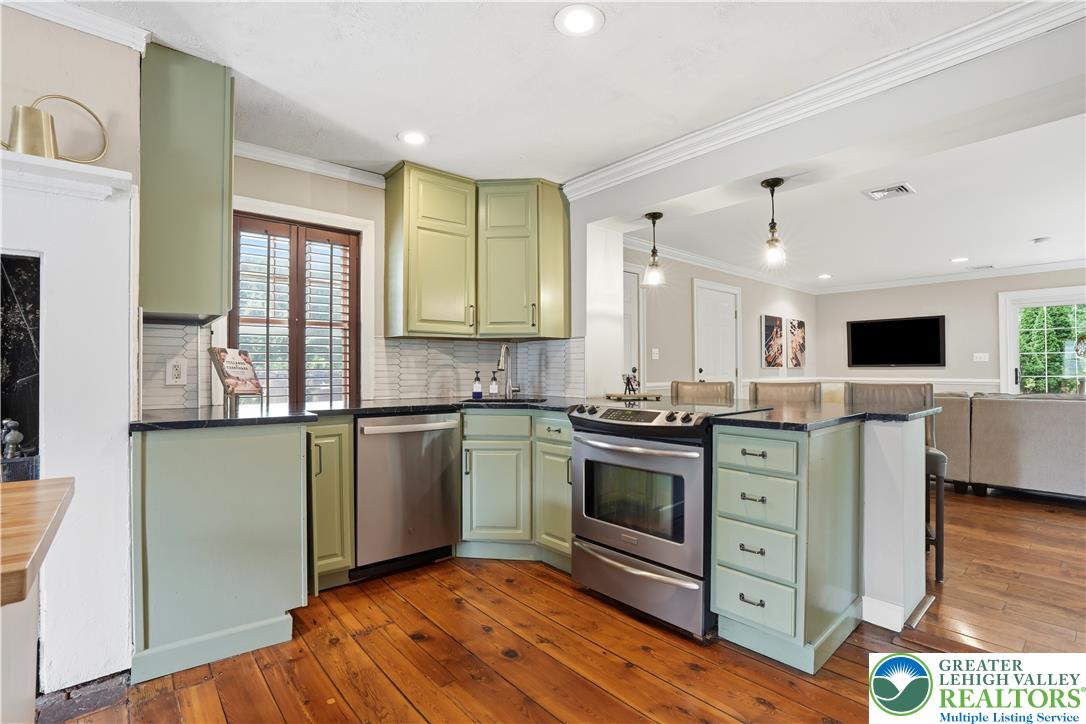 2014 Linden Street Bethlehem, PA 18017 - Photo 26 of 85 A well-appointed kitchen features rich hardwood flooring and sleek stainless steel appliances, opening to an inviting living area.