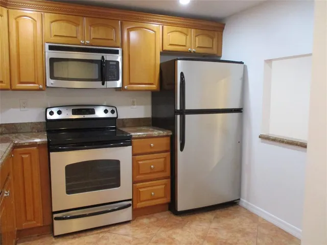 a kitchen with a refrigerator stove and microwave