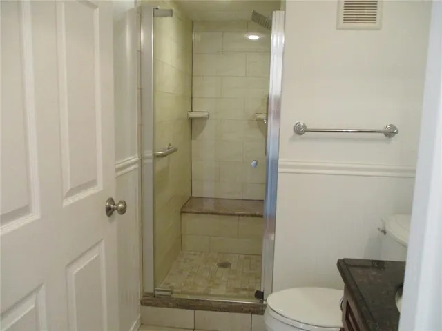 a bathroom with a shower and a toilet
