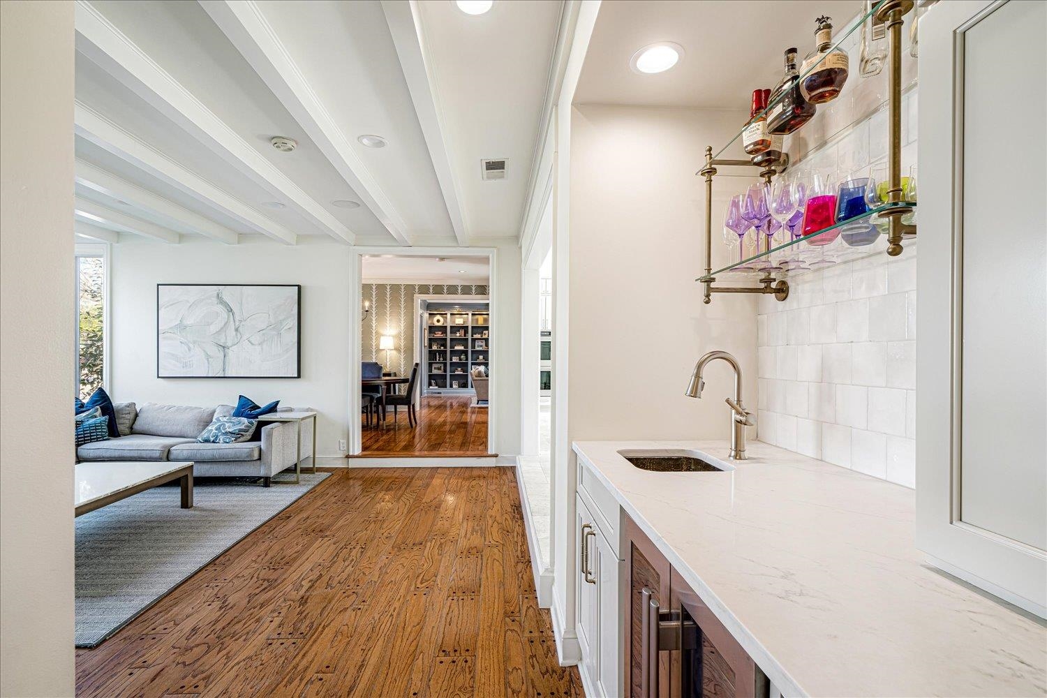 4160 Tuckahoe Road Memphis, TN 38117 - Photo 18 of 39 Indoor wet bar with light stone countertops, dark wood-type flooring, open shelves, beamed ceiling, and wine cooler