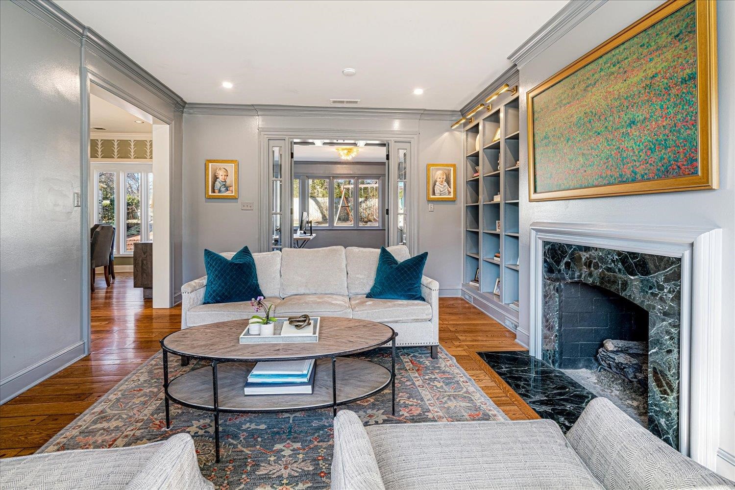 4160 Tuckahoe Road Memphis, TN 38117 - Photo 7 of 39 Living room with wood finished floors, a fireplace, ornamental molding, built in features, and recessed lighting