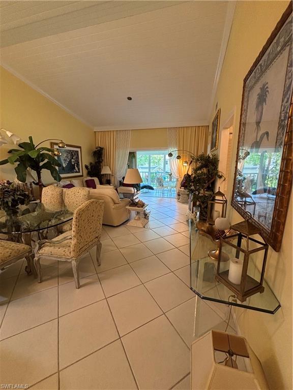 Undisclosed Address Naples, FL 34112 - Photo 11 of 35 Tiled living room/dining area with ornamental molding