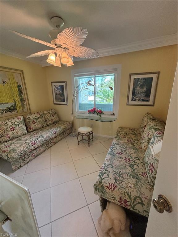 Undisclosed Address Naples, FL 34112 - Photo 17 of 35 Guest bedroom room featuring crown molding, tile patterned flooring, and a ceiling fan