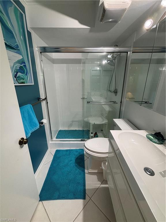 Undisclosed Address Naples, FL 34112 - Photo 28 of 35 Bathroom featuring tile patterned flooring, toilet, and a shower stall