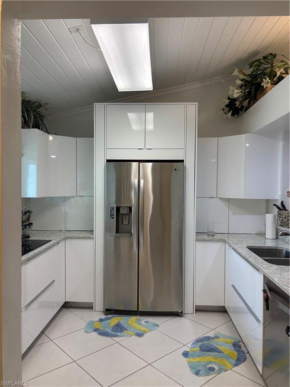 Undisclosed Address Naples, FL 34112 - Photo 3 of 35 Kitchen featuring dishwashing machine, modern cabinets, white cabinets, and stainless steel refrigerator with ice dispenser