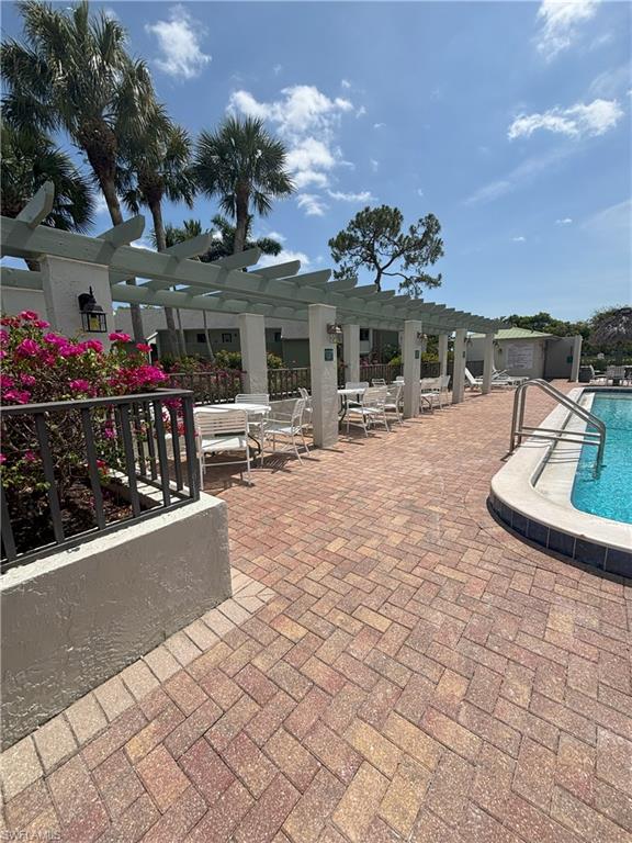 Undisclosed Address Naples, FL 34112 - Photo 32 of 35 Community pool featuring a pergola and a patio area