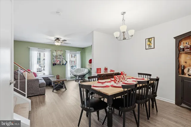 a view of a dining room with furniture wooden floor and chandelier