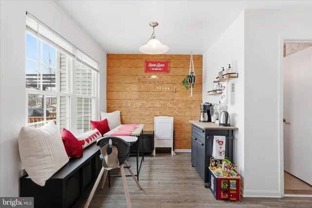 a living room with furniture a rug and a window
