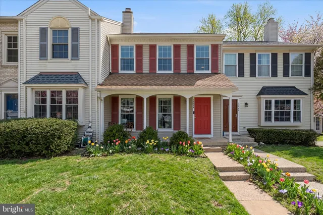 a front view of a house with garden and porch