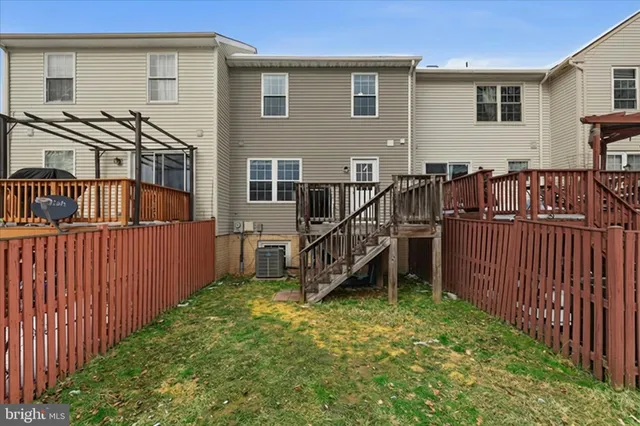 a view of a house with wooden deck front of house
