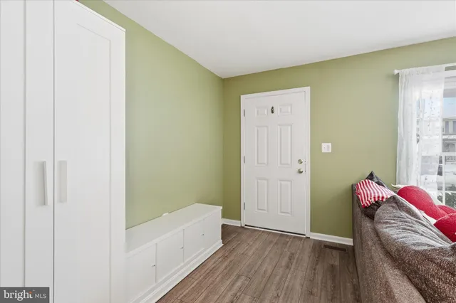 a view of room with furniture and wooden floor