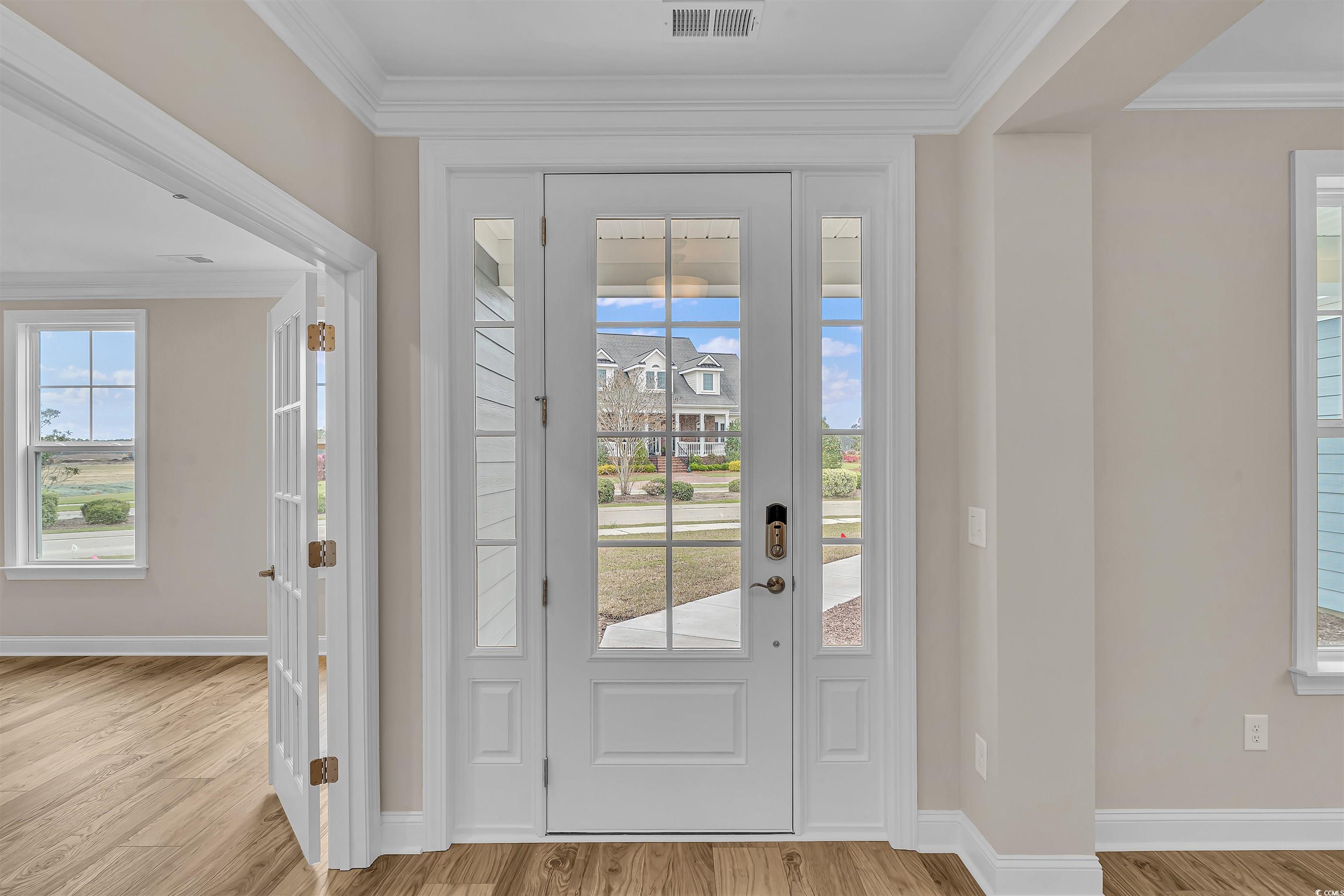 550 Beachside Circle Calabash, NC 28467 - Photo 11 of 39 Foyer entrance featuring crown molding and light hardwood / wood-style floors