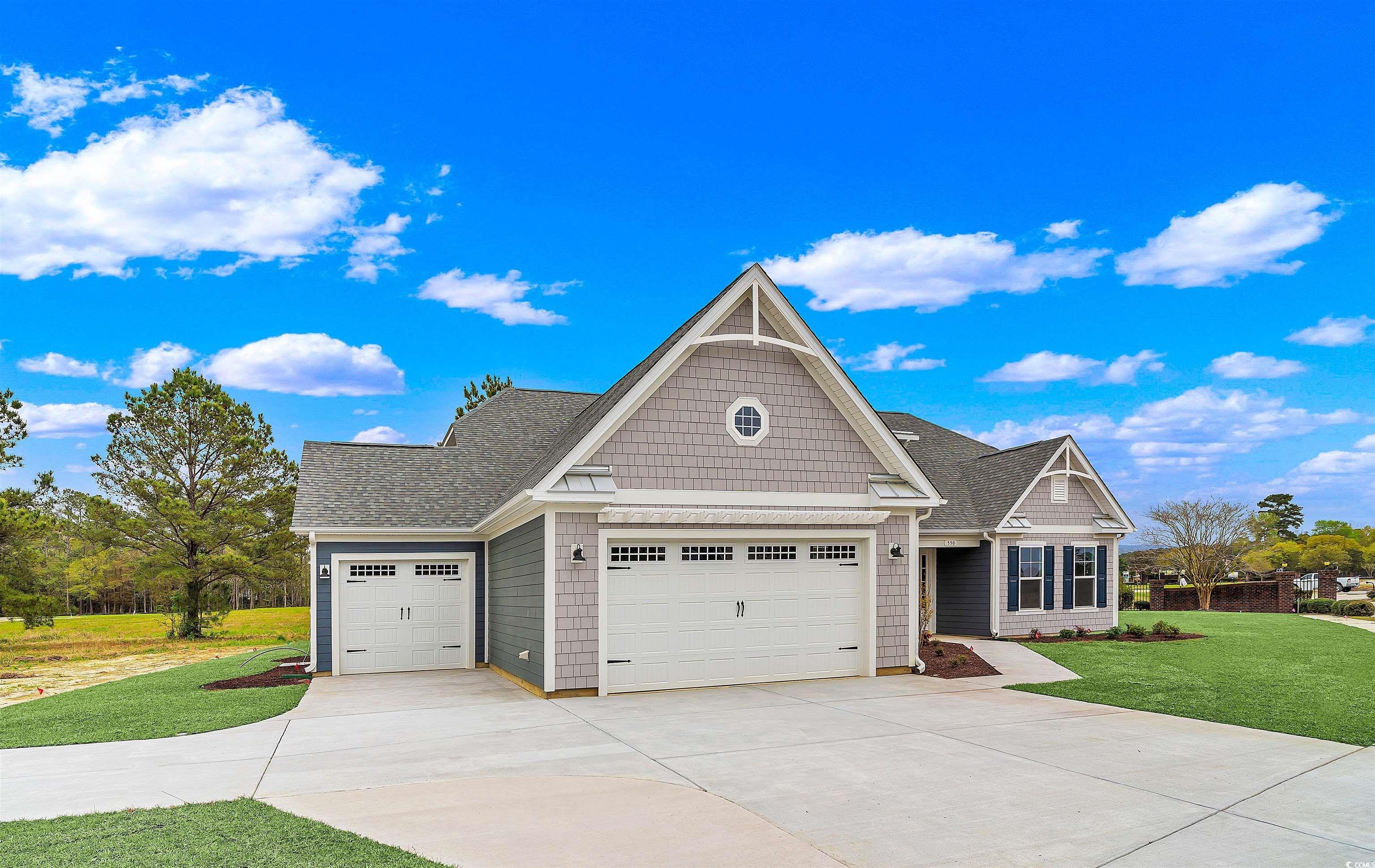 550 Beachside Circle Calabash, NC 28467 - Photo 2 of 39 Craftsman house with a front lawn and a garage