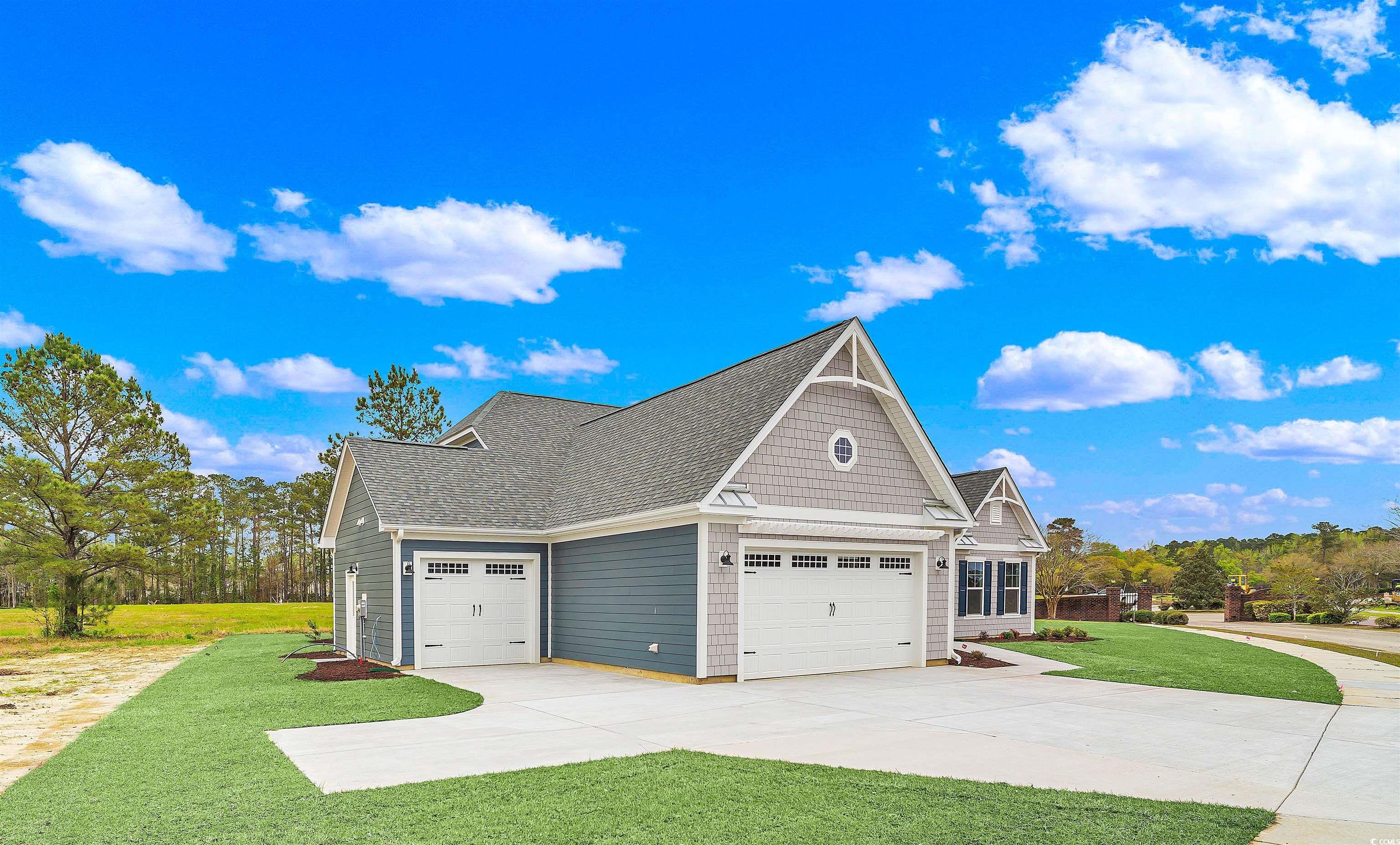 550 Beachside Circle Calabash, NC 28467 - Photo 3 of 39 View of home's exterior featuring a yard and a garage