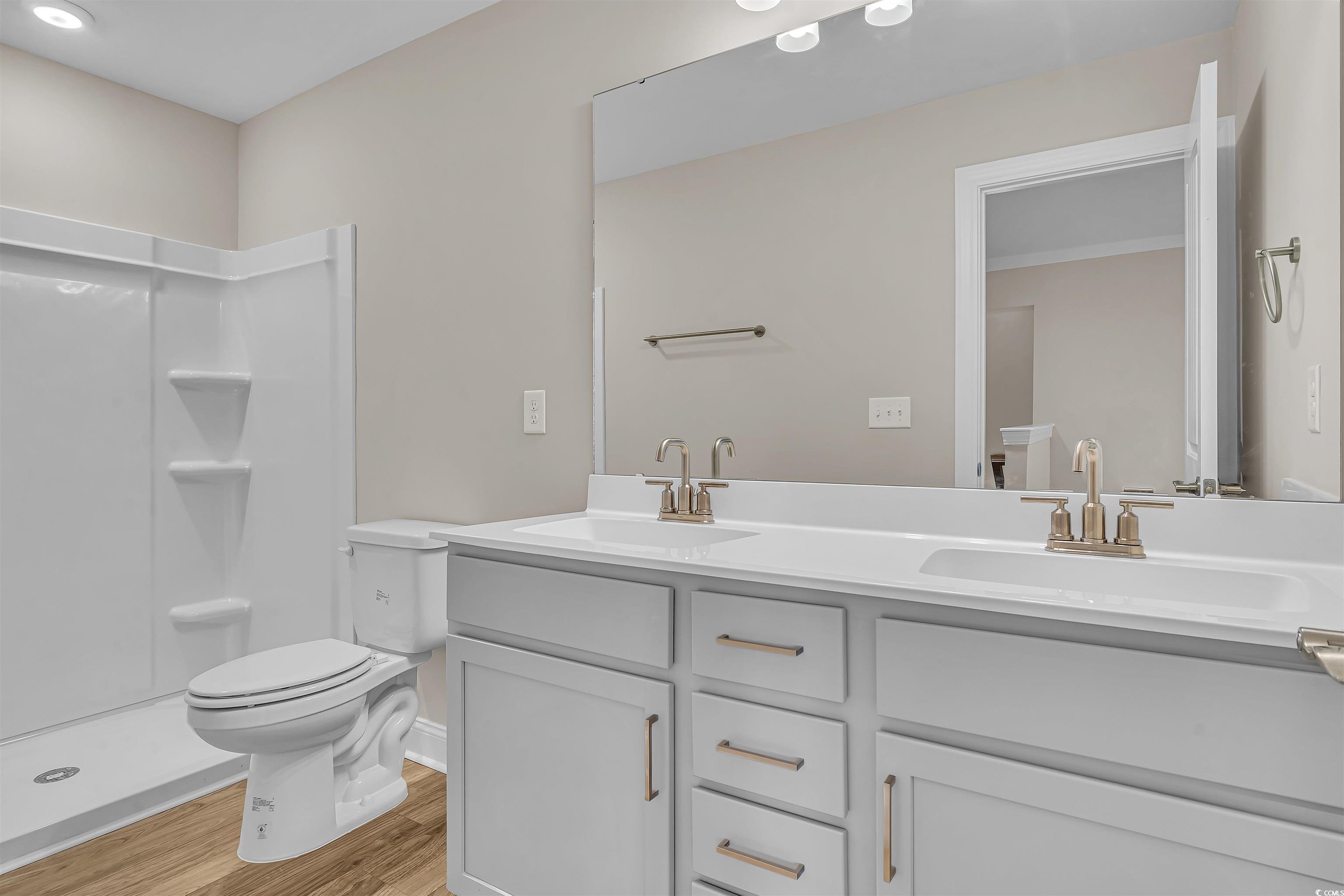 550 Beachside Circle Calabash, NC 28467 - Photo 37 of 39 Bathroom featuring vanity, hardwood / wood-style flooring, toilet, and walk in shower
