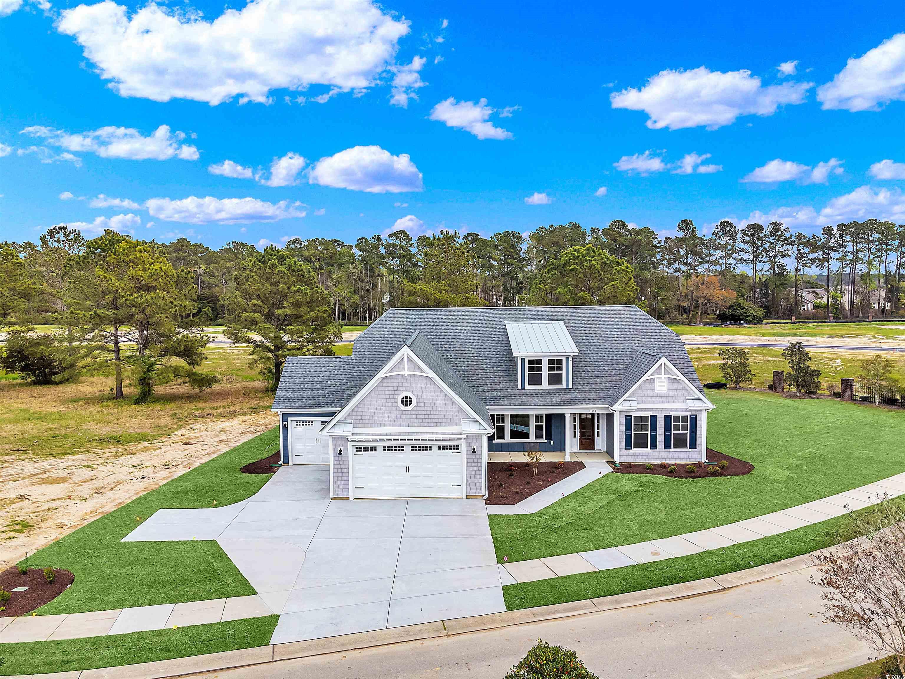 550 Beachside Circle Calabash, NC 28467 - Photo 5 of 39 View of front of home featuring a front lawn, a porch, and a garage