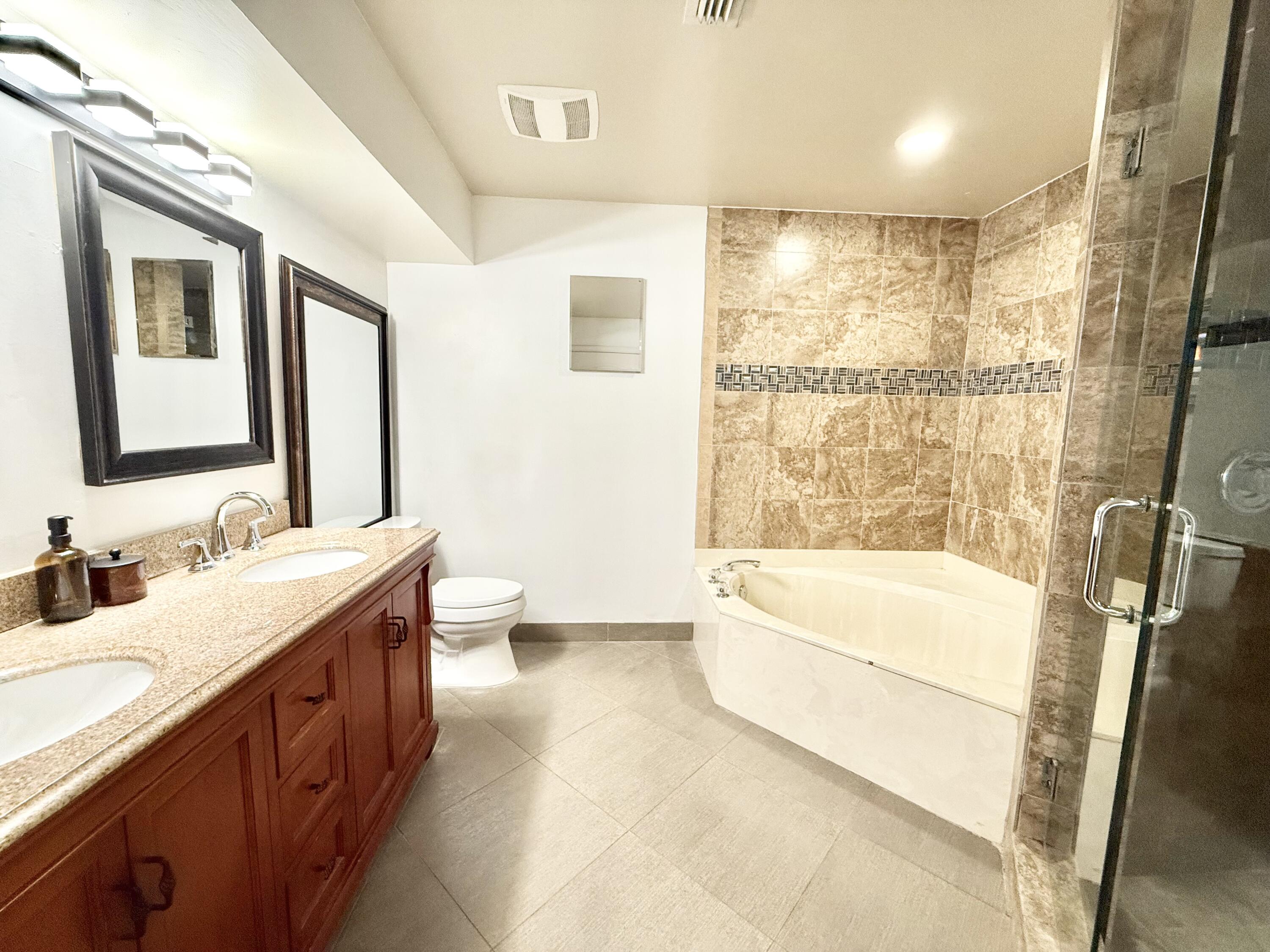 9190 Boca Gardens Parkway, Unit B Boca Raton, FL 33496 - Photo 9 of 35 a bathroom with a double vanity sink a toilet and shower