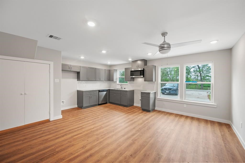 7804 Crestview Drive, Unit B Houston, TX 77028 - Photo 2 of 23 a view of an empty room with a window and wooden floor