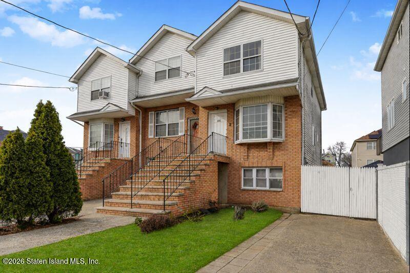 225 Colony Avenue Staten Island, NY 10306 - Photo 1 of 20 a view of a brick house next to a yard