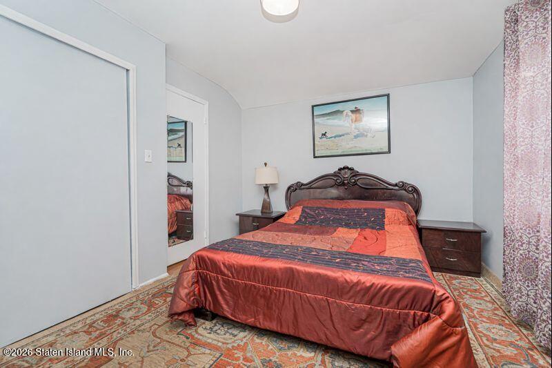 225 Colony Avenue Staten Island, NY 10306 - Photo 11 of 20 a bedroom with a bed and painting on the wall