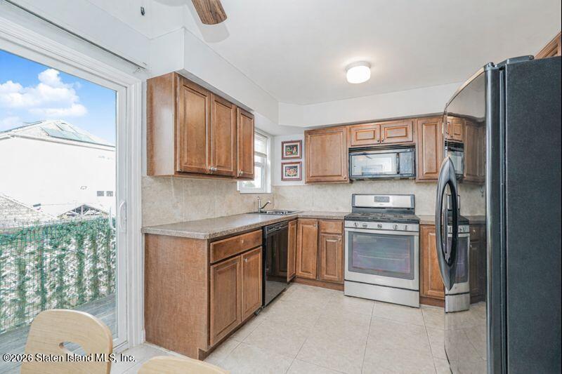 225 Colony Avenue Staten Island, NY 10306 - Photo 6 of 20 a kitchen with stainless steel appliances granite countertop a refrigerator stove and sink