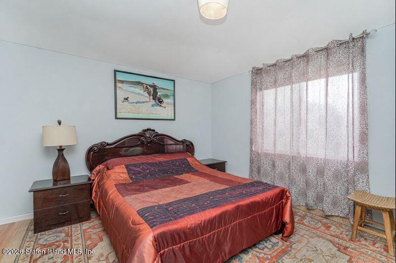 225 Colony Avenue Staten Island, NY 10306 - Photo 10 of 20 a bedroom with a bed and a lamp