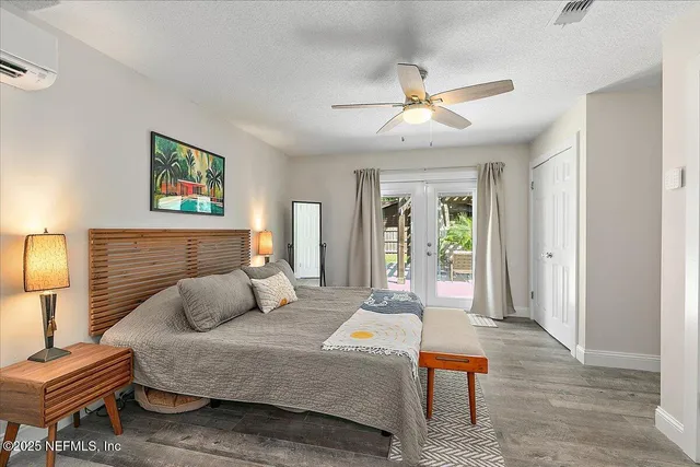 a bedroom with a bed and a chandelier