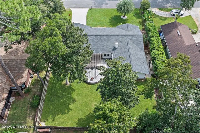an aerial view of a house with a yard