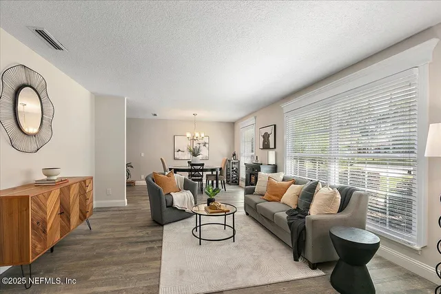 a living room with furniture and wooden floor