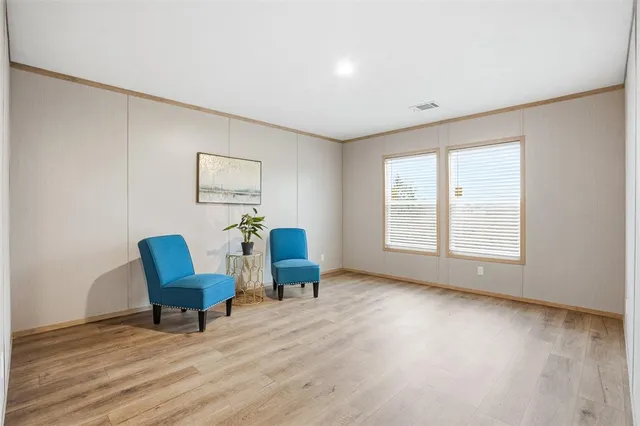 a view of a livingroom with chair and a couch