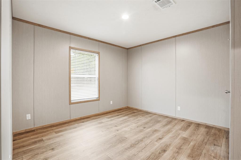 2000 Atticus Court Springtown, TX 76082 - Photo 14 of 25 an empty room with wooden floor and windows