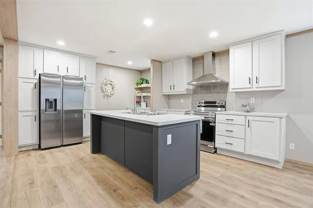 a kitchen with a refrigerator sink and cabinets